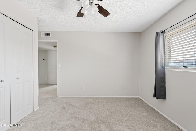 12201 N 22nd Pl, Phoenix, AZ 85022 - unfurnished bedroom featuring light colored carpet, a textured ceiling, a closet, and a ceiling fan