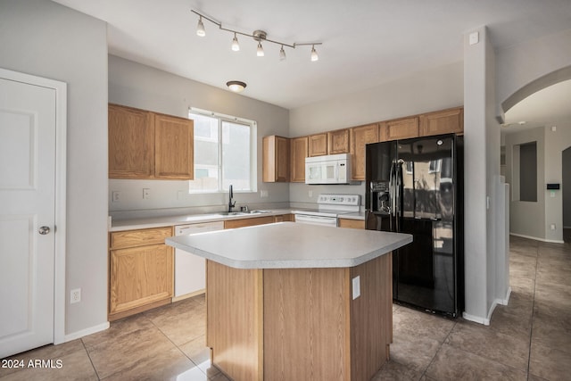 kitchen featuring a kitchen island, sink, light tile patterned floors, and white appliances