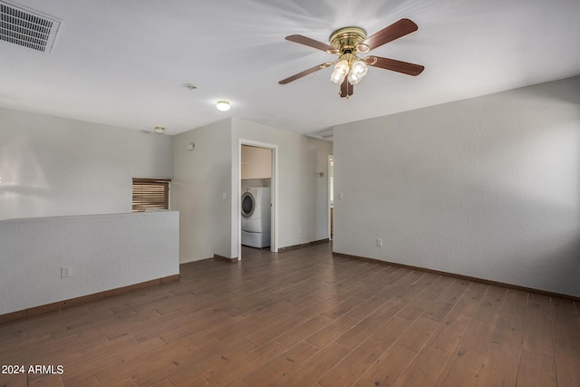 spare room with washer / clothes dryer, ceiling fan, and dark hardwood / wood-style floors