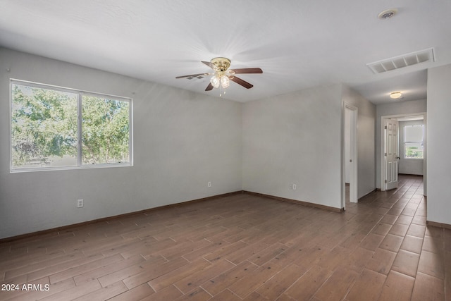 unfurnished room with ceiling fan and hardwood / wood-style flooring