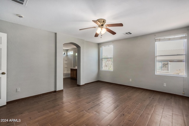 spare room featuring ceiling fan and dark hardwood / wood-style floors