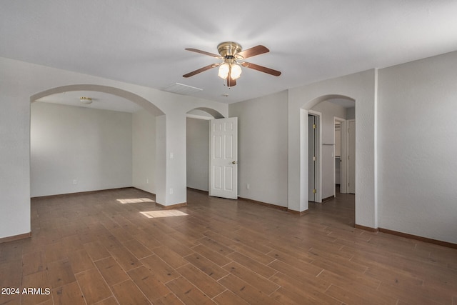 spare room featuring ceiling fan and dark hardwood / wood-style floors