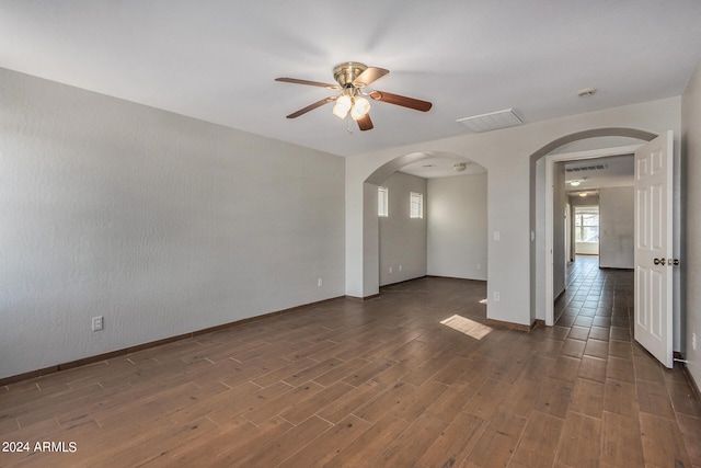 unfurnished room with ceiling fan and dark hardwood / wood-style flooring