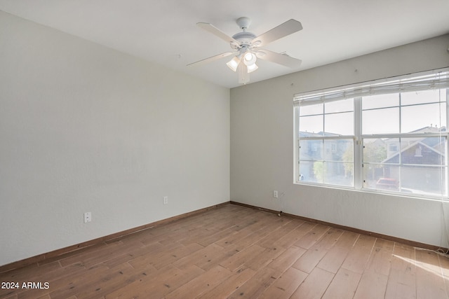 spare room with light hardwood / wood-style flooring and ceiling fan