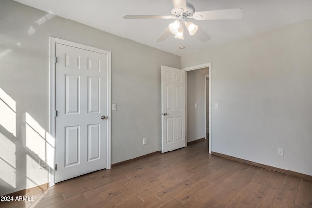 empty room featuring ceiling fan and hardwood / wood-style flooring