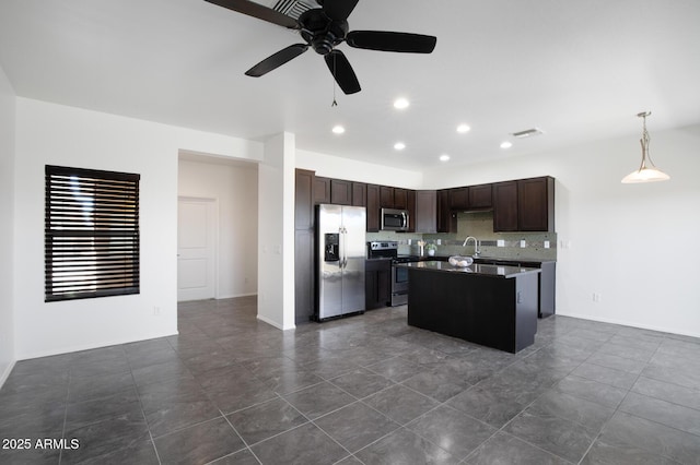 3113 E Danbury Rd Unit 10, Phoenix, AZ 85032 - kitchen featuring stainless steel appliances, a sink, a kitchen island, a ceiling fan, and dark brown cabinetry