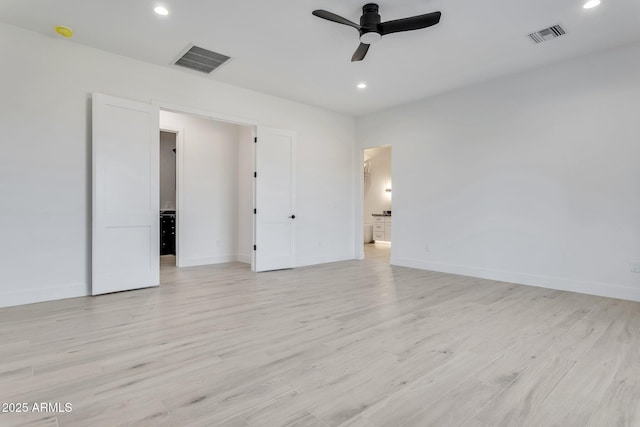 unfurnished room with baseboards, visible vents, and light wood finished floors