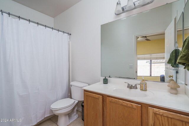 bathroom featuring tile patterned floors, vanity, and toilet