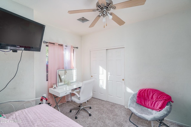 carpeted bedroom featuring a closet and ceiling fan