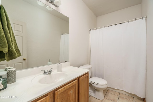 bathroom with tile patterned flooring, vanity, and toilet