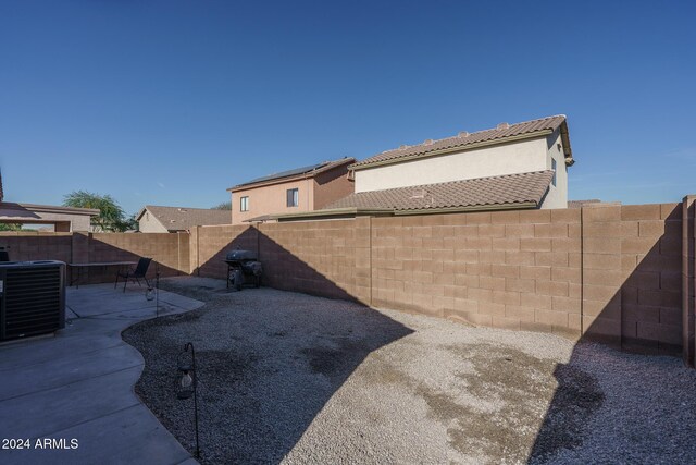 view of yard featuring central AC unit and a patio area