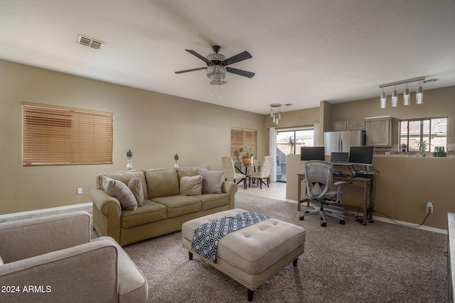 carpeted living room featuring ceiling fan and rail lighting