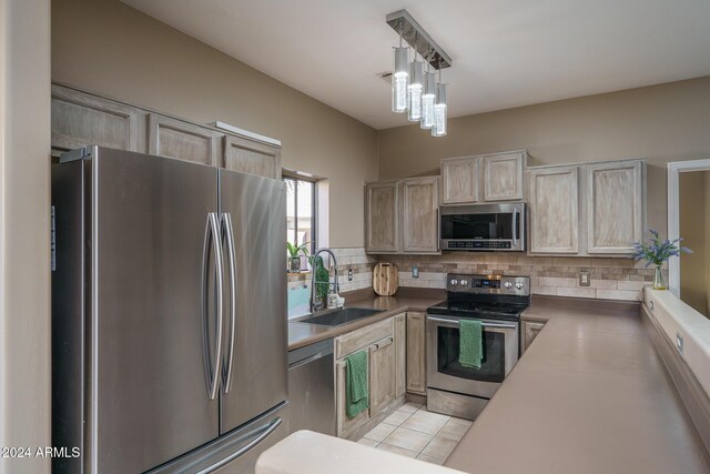 kitchen featuring light brown cabinets, backsplash, stainless steel appliances, and sink