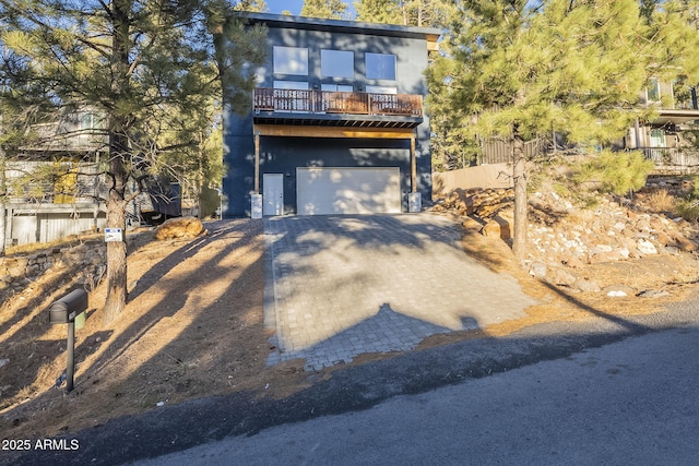 view of front of house featuring a garage and a balcony