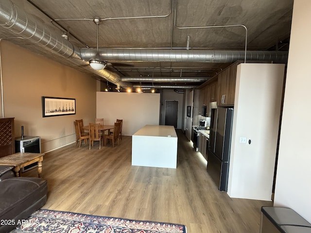 kitchen featuring wood finished floors and freestanding refrigerator