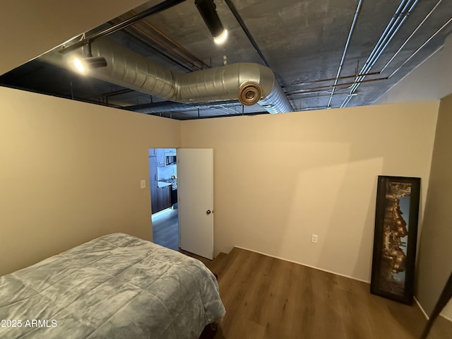 bedroom with wine cooler and wood finished floors