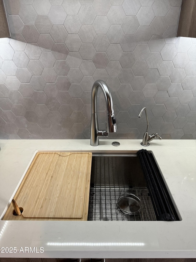 room details featuring light countertops and a sink