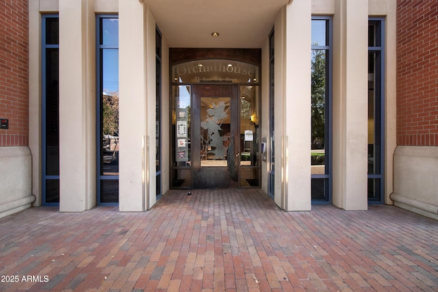 view of exterior entry with brick siding