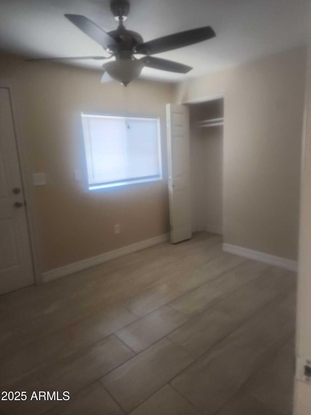 unfurnished bedroom with a closet and ceiling fan