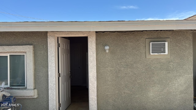 doorway to property featuring stucco siding