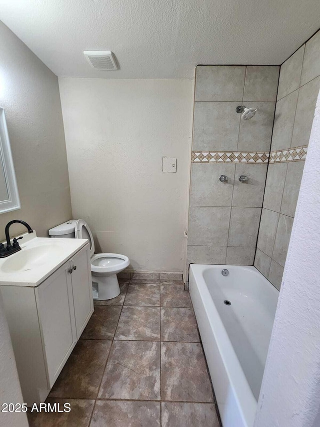 full bathroom with toilet, vanity, visible vents, tile patterned floors, and bathing tub / shower combination