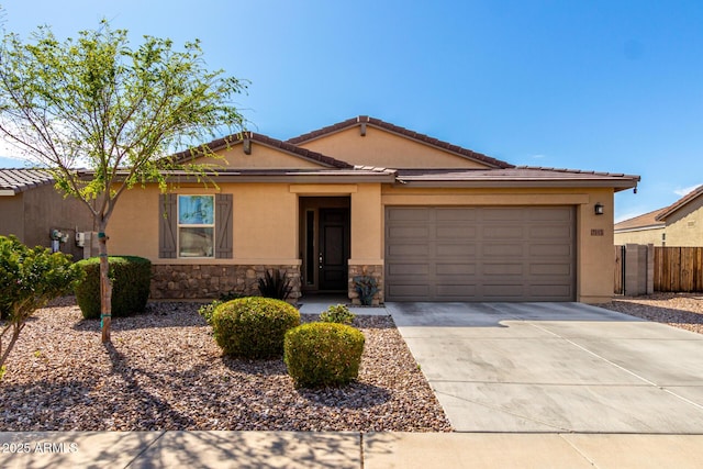 ranch-style home with stucco siding, driveway, stone siding, fence, and an attached garage