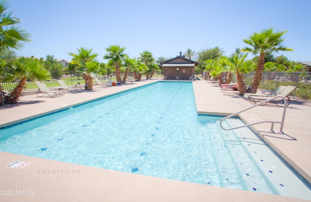 pool with fence and a patio