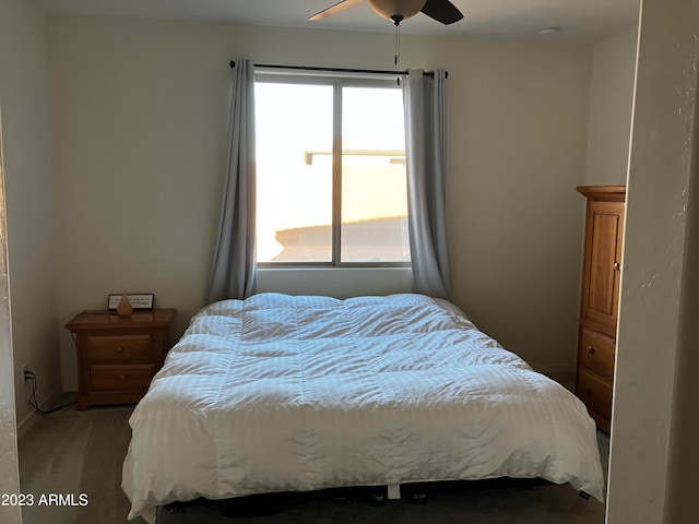 bedroom with ceiling fan and dark colored carpet