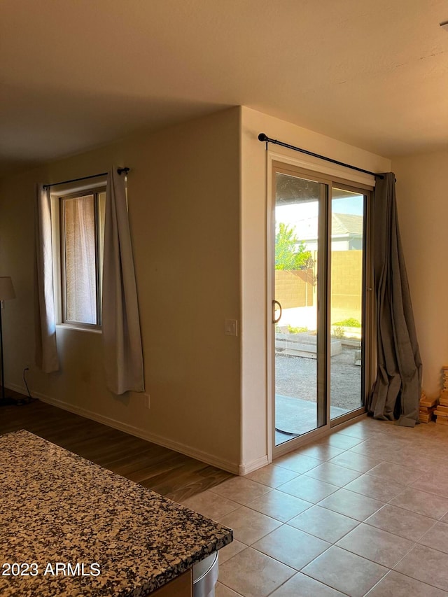 spare room with light tile floors and a wealth of natural light