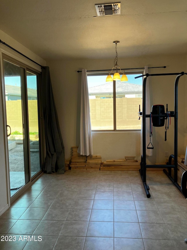 workout area featuring light tile flooring