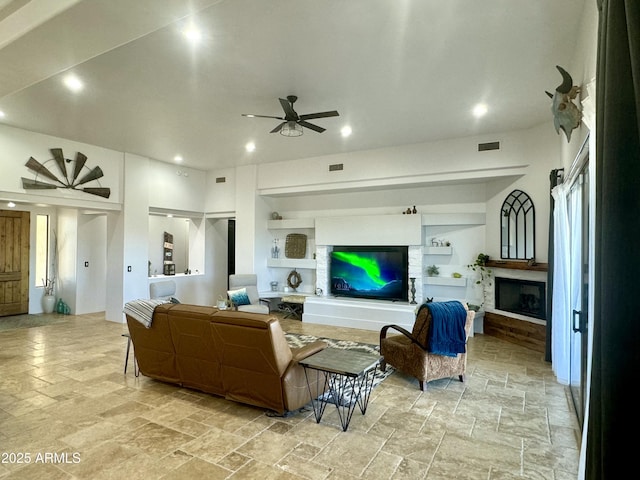 living room with a fireplace, recessed lighting, visible vents, a ceiling fan, and stone finish flooring