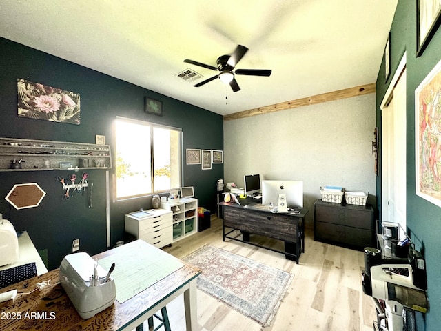 bedroom featuring a ceiling fan, visible vents, and wood finished floors