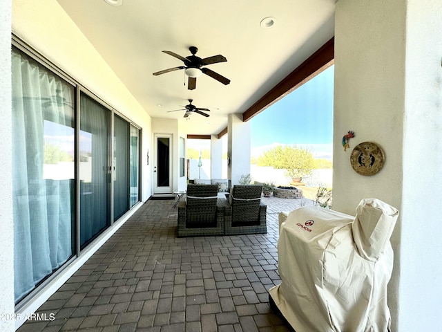 view of patio with ceiling fan and an outdoor hangout area