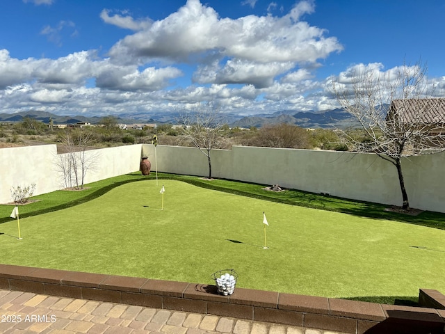 view of community featuring a fenced backyard and a mountain view