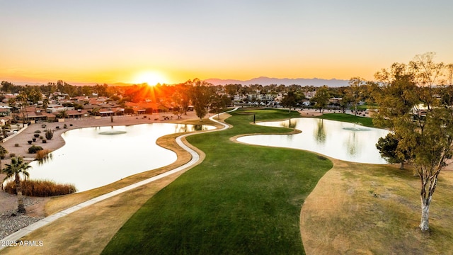 surrounding community with a yard and a water view