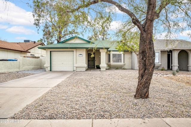 view of front of house featuring a garage, driveway, and stucco siding