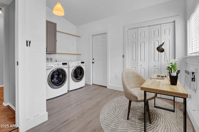 laundry room featuring cabinet space, independent washer and dryer, light wood-style flooring, and baseboards