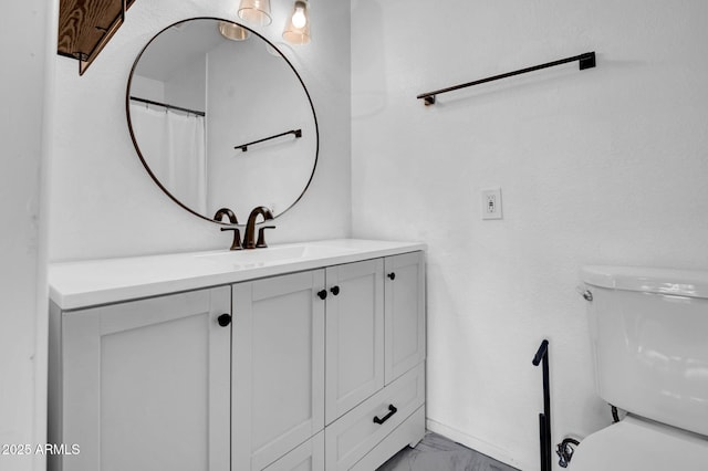 full bath with marble finish floor, vanity, and toilet