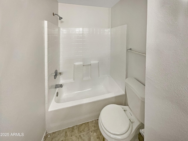 bathroom featuring bathing tub / shower combination, tile patterned floors, and toilet