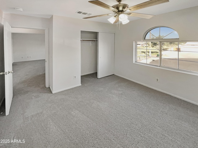 unfurnished bedroom featuring carpet floors, a closet, and ceiling fan