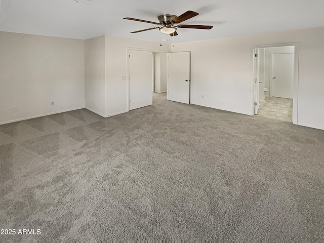 unfurnished room featuring ceiling fan and carpet