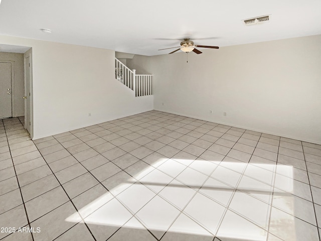 unfurnished room with light tile patterned floors and ceiling fan