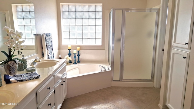 bathroom featuring plus walk in shower, tile patterned floors, and vanity