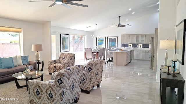 living room featuring ceiling fan, sink, and lofted ceiling