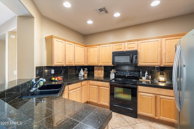 kitchen featuring tasteful backsplash, a sink, tile countertops, and black appliances