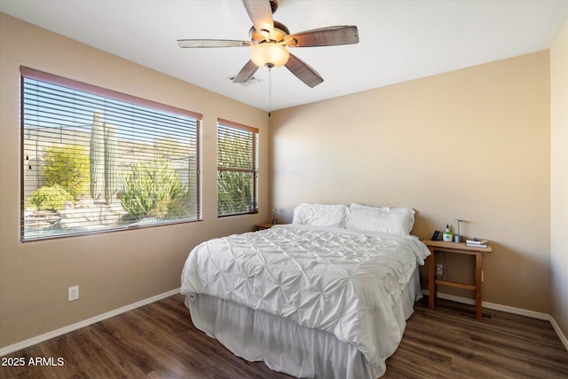 bedroom featuring ceiling fan, dark wood finished floors, visible vents, and baseboards