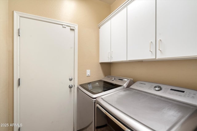 laundry area featuring independent washer and dryer and cabinet space