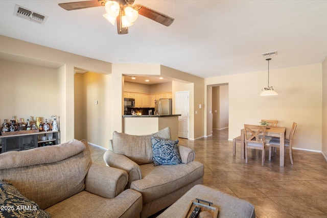 living area with baseboards, visible vents, ceiling fan, and recessed lighting