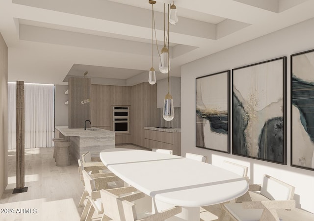 dining area with light hardwood / wood-style floors and sink