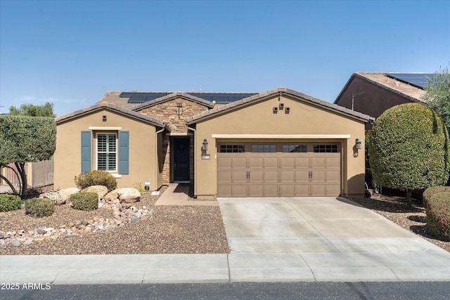 ranch-style home featuring a tile roof, stucco siding, roof mounted solar panels, a garage, and driveway